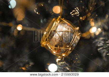 Christmas golden silver drum hanging on a beautiful Chrismas tree surrounded by red shinning ball