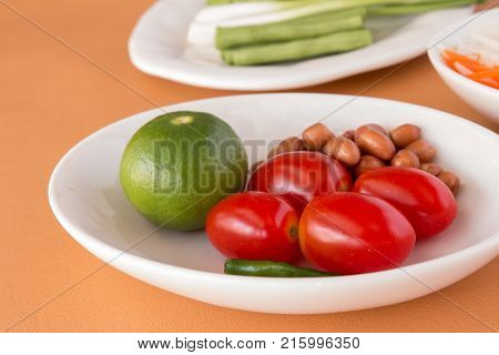 Papaya Salad - Tomatoes Lemon Roasted peanuts Long-beans for Green Papaya Salad with Carrot and lettuce. Traditional spicy Thai food. Closeup