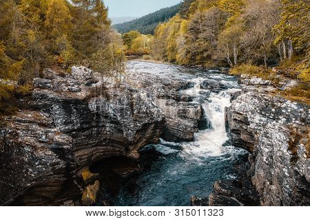 River Moriston Falls At Invermoriston In Scotland Surrounded By Woodland
