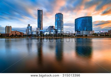 Beautiful Wide Angle Long Exposure Cityscape Of Yekaterinburg City, Russia At Sunset With Blurred Bl