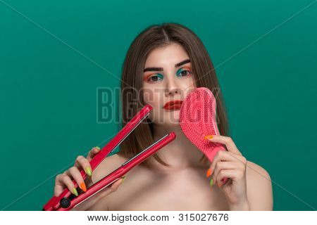 Portrait Of Beautiful Young Woman With Bright Color Make-up Doing Hair Style Herself With A Purple S