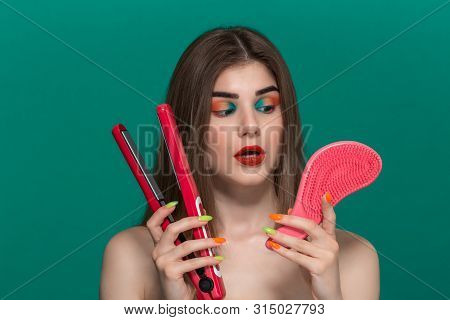 Portrait Of Beautiful Young Woman With Bright Color Make-up Doing Hair Style Herself With A Purple S