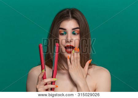 Portrait Of Beautiful Young Woman With Bright Color Make-up Doing Hair Style Herself With A Purple S