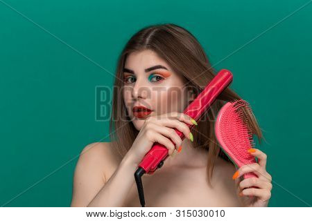Portrait Of Beautiful Young Woman With Bright Color Make-up Doing Hair Style Herself With A Purple S
