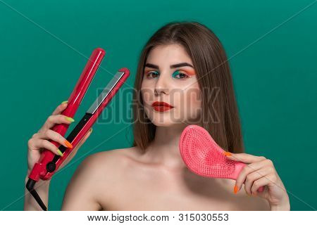 Portrait Of Beautiful Young Woman With Bright Color Make-up Doing Hair Style Herself With A Purple S