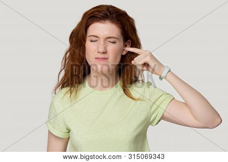 Studio Headshot Young Woman Suffering From Ear Pain Or Noise