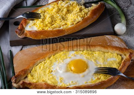 A man mixes ajar khachapuri stuffing. Stuffing from cheese, eggs and butter. Oven cake served for fo