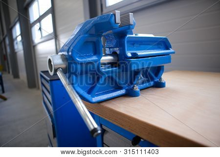 Shallow Depth Of Field Image With A Heavy Iron Vice On A Workbench Inside A Workshop With No People 
