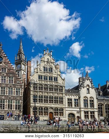 Gent, Flanders, Belgium -  June 21, 2019: School Children And Students Enjoying Sun Sitting On Quay 