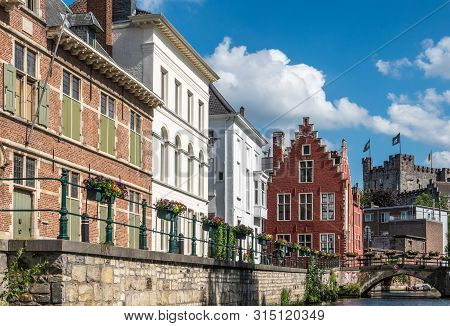 Gent, Flanders, Belgium -  June 21, 2019: Narrow Lieve River Leads Along Old Bourgeois Mansions To G