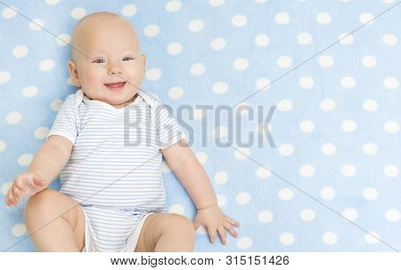 Happy Baby Boy, Smiling Infant Kid Portrait, Five Months Old Child Lying On Back On Blue Background