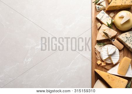 Different Delicious Cheeses Served On Grey Table, Top View. Space For Text