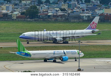 Saigon, Vietnam - Jul 13, 2019. Passenger Airplanes Taxiing On Runway Of Tan Son Nhat Airport (sgn) 