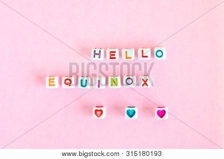 Phrase Hello Equinox Made Out Of Beads On Pink Background