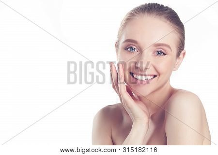 Portrait Of Beautiful Woman With Natural Make Up Touching Her Face.