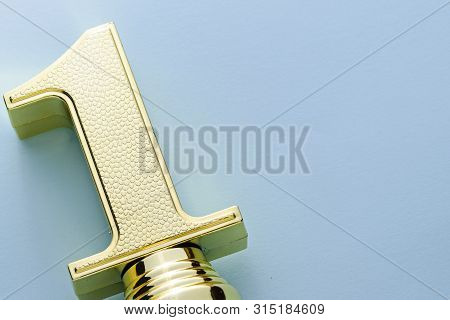 Textured Decorative Gold Winners Trophy Number One Over A Grey Stdio Background With Copy Space Plac