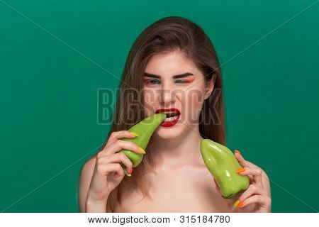 Closeup Portrait Of Beautiful Young Woman With Bright Color Make-up Holding Green Pepper Standing Is