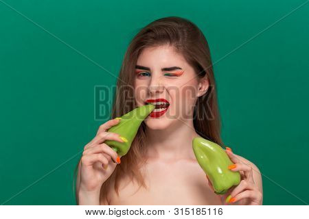 Closeup Portrait Of Beautiful Young Woman With Bright Color Make-up Holding Green Pepper Standing Is