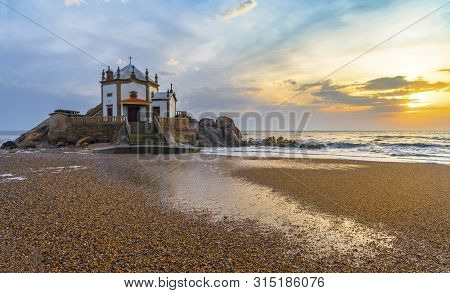 Sunset View On Capella Do Senhor Da Pedra At The Atlantic Ocean