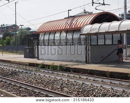 Collegno, Italy - Circa August 2019: Passenger Waiting For Train At Collegno Railway Station