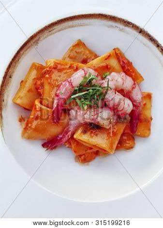 Italian Traditional Paccheri (short Pasta From Gragnano) With Shrimps And Burned Onions Cream