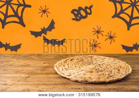 Halloweeen Background With Empty Wooden Table And Wicker Round Placemat