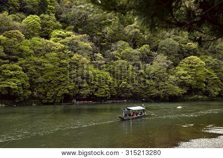 Arashiyama, Japan - April 17th, 2018: Tourists Cruising Down The Hozu River In Arashiyama, Japan