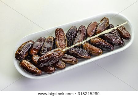 A Tray Of Sweet Juicy Crinkly Dates Ready To Eat.