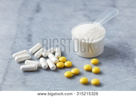 Collagen Powder, Proline Capsules And Vitamin C Tablets. Supplements To Support Collagen Production.