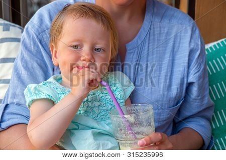 Fresh Juice From Organic Fruits And Berries. Child On Mothers Knees Drinking Fresh Healthy Drink. Nu