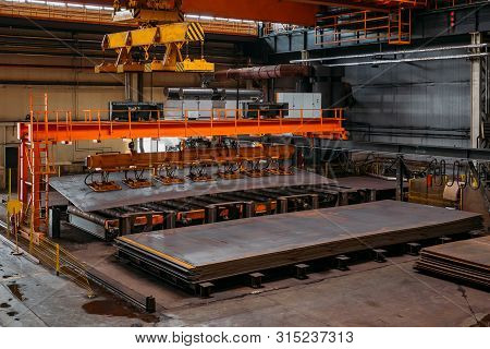 Overhead Crane With Vacuum Handling Grippers Lifting Iron Sheets.