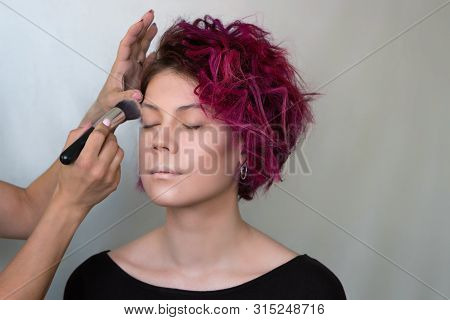 Makeup Artist Applies Foundation Concealer On Your Face Model Special Brush. Work Of Professional Be
