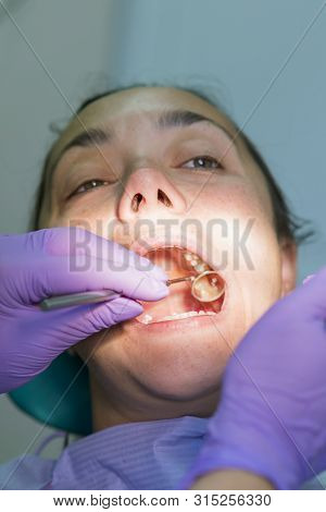 Dentist And Patient In Dentist Office. Close-up Of Dental Drill Use For Patient Teeth In Dentistry O