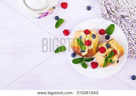 Rum Baba Decorated With Whipped Cream And Fresh Raspberry, Blueberry. Savarin With Rum, Cream And Be
