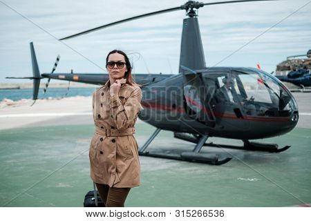 Business woman near private a helicopter