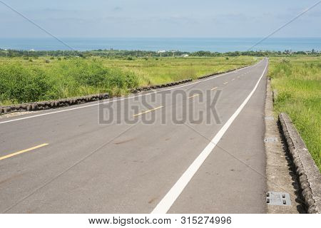 road at green paddy farm in the countryside