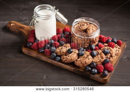 Composition Of Tasty Chocolate Oatmeal Cookies With Bluebarries And Milk
