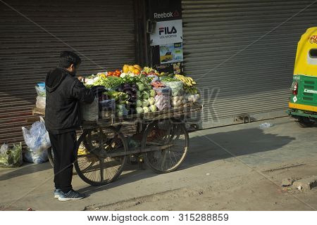 Indian People Sale And Buy Food Product Fruit Vegetable From Small Local Grocery Cart At Janpath Mar