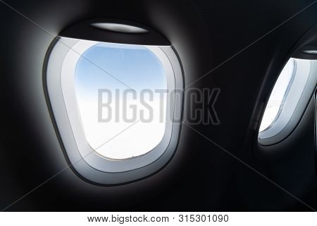 Airplane Window View To Cloudy Sky And Earth. Beautiful Landscape From Aircraft Cabin. Flying Withou
