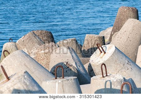 Breakwaters In Sea. Beautiful Sunset Seascape With Concrete Tetrapodes For Protect Coastal Structure