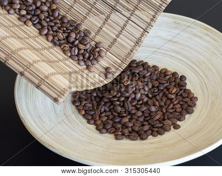 Selected Arabica Beans Are Poured Into A Wooden Plate