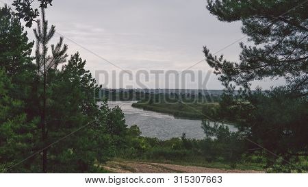 Large Lake On A Sunny Day Against The Background Of A Dense Green Forest, Nature In Russia