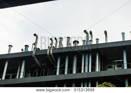Close Up Of The Factory Building With The Blue Sky.the Air Duct System Where Installed At The Factor