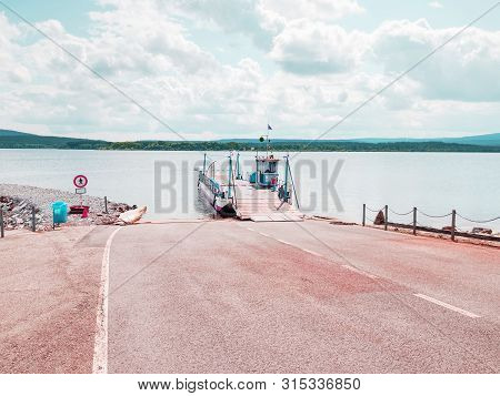 Shipping On Ferry Boat Ship With Open Ramp And Empty Car Deck. Wooden Board For Cars And Passenger