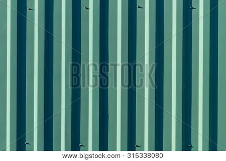 Green And Dark Green And Light Dreen Textured Background Of Vertical Slats.  Front View.