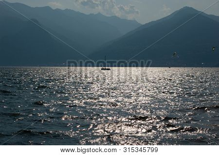 Boat In The Mountain Lake. District Of Como Lake, Colico, Italy, Europe. Evening Light