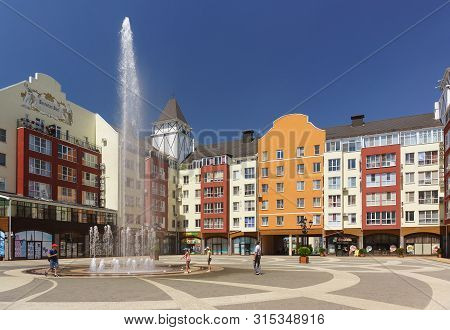German Village, Krasnodar, Russia - June 09, 2019: Children Play Near The High Fountain Soaring Jets