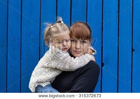 Middle Aged Woman Holding Child On Hands