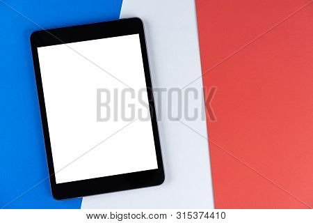Black Tablet, E-book Is On Flag France. Texture French National Flag Colored Cardboard. Mock Up, Cop
