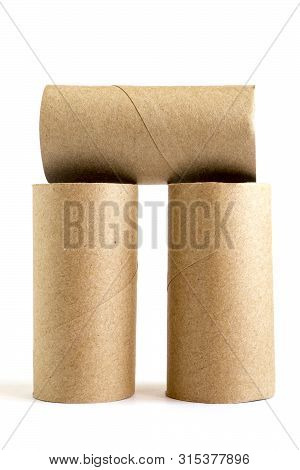 Composition From Three Cardboard Paper Tubes On White Background. Close-up Of Empty Toilet Rolls